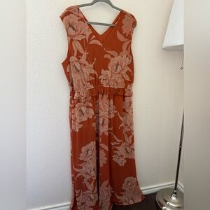 Floor length terracotta dress with floral design.